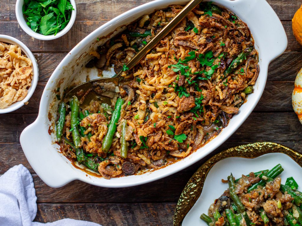Golden baked Vegan Green Bean Casserole topped with crispy onion strings and fresh parsley.