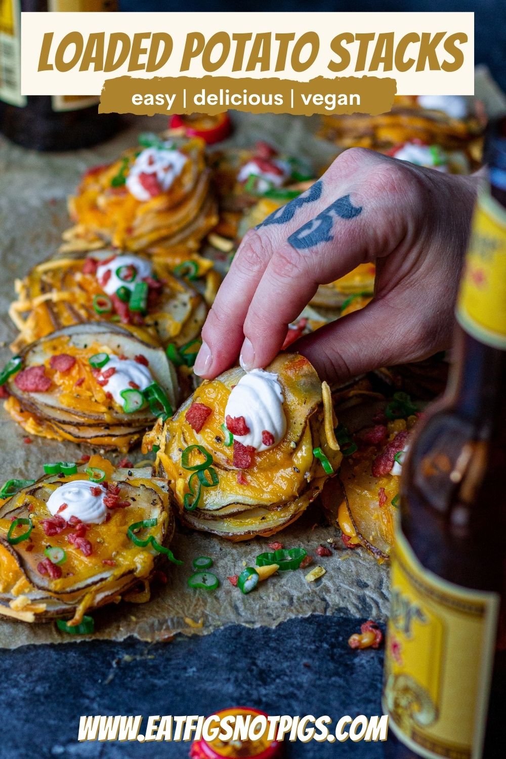 A platter of cheesy loaded potato stacks garnished with sour cream, bacon bits and chives, ready to serve.