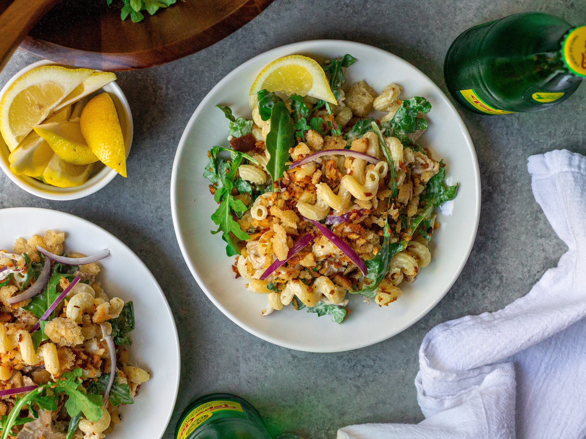 Chick’n Caesar Pasta Salad topped with lemon-garlic breadcrumbs and red onion