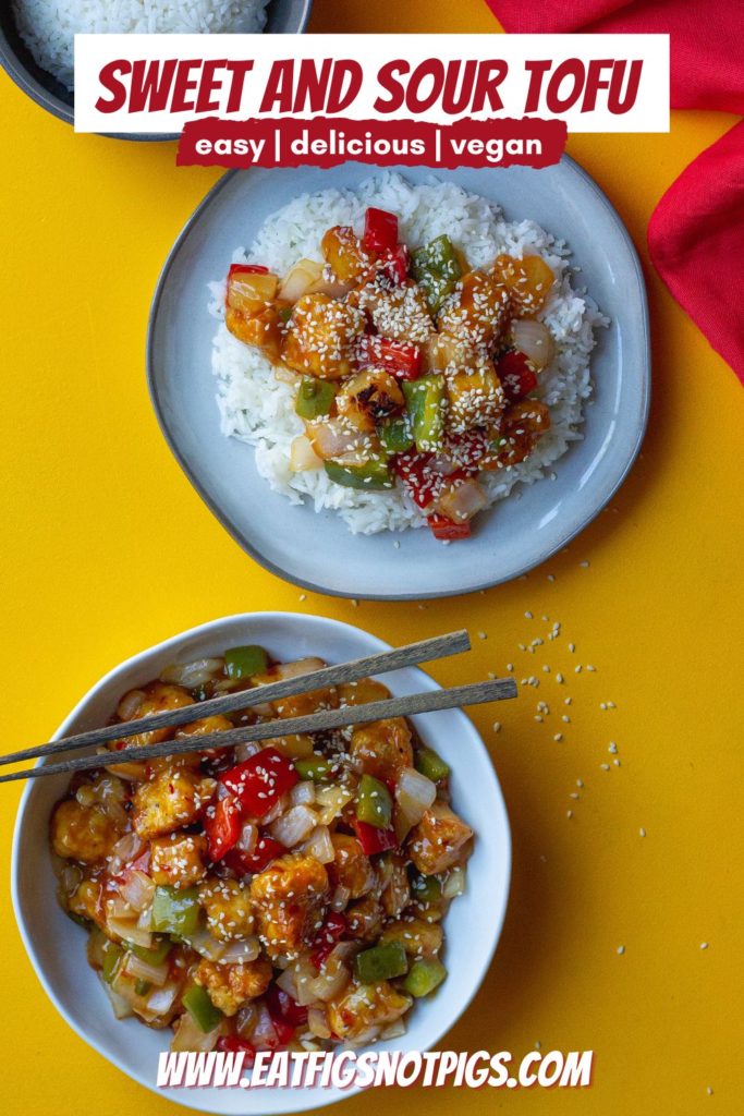A plate of crispy sweet and sour tofu with bell peppers and pineapple over white rice garnished with toasted sesame seeds and thinly sliced green onion.