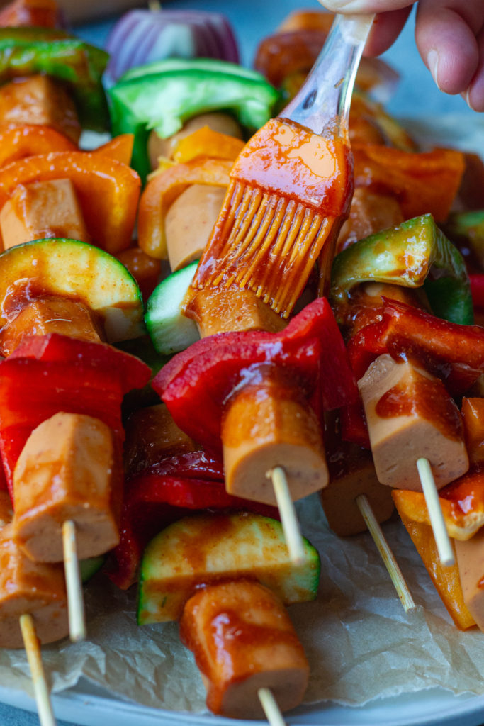vegan hot dog skewers with vegetables and sriracha glaze