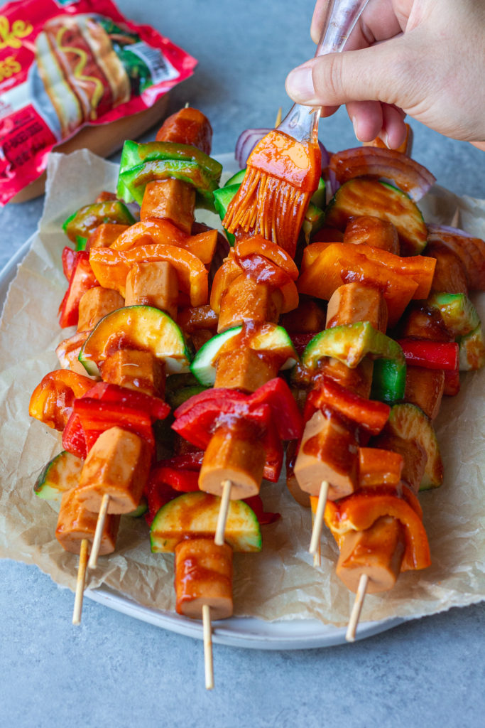 vegan hot dog skewers with vegetables and sriracha glaze