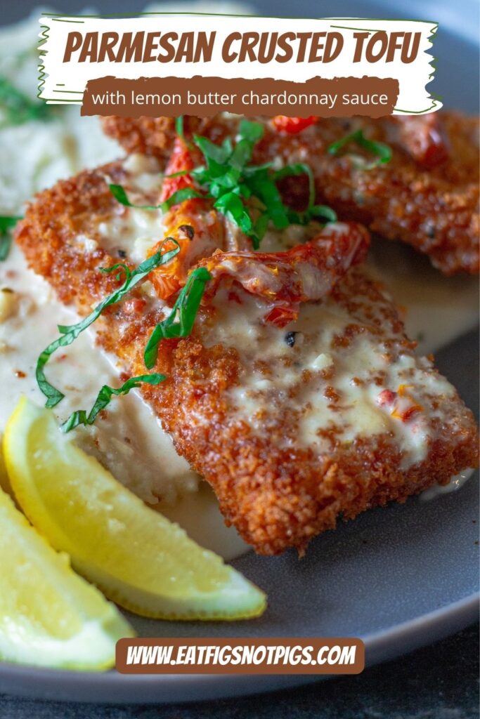 Finished dish of Parmesan-Crusted Tofu plated with lemon sauce, sundried tomatoes, and fresh basil