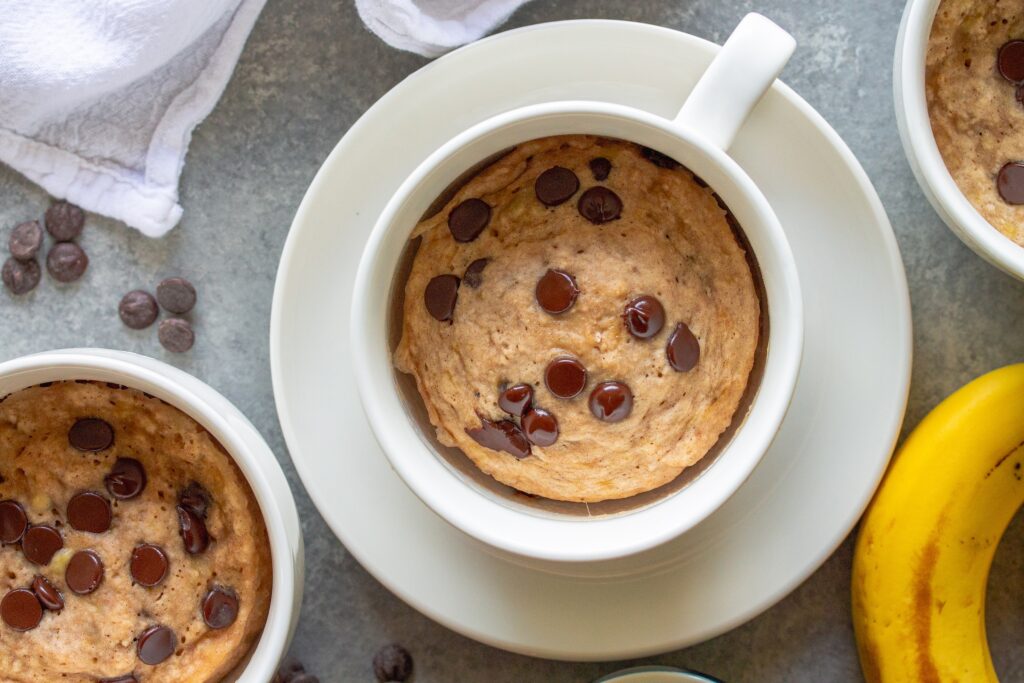 Optional toppings on the finished mug cake, including chocolate chips, for added visual appeal.