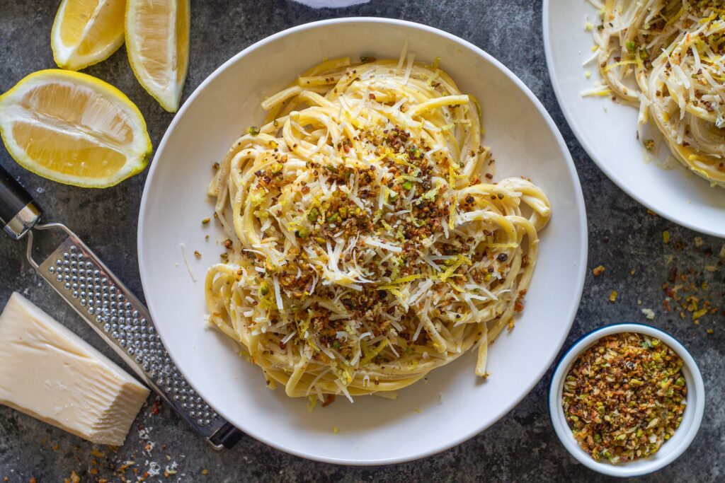 Cooked pasta coated in creamy lemon sauce with garlicky pistachio breadcrumbs.