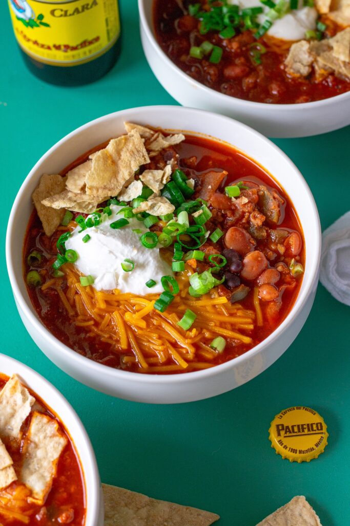 A beautifully plated serving of the best vegan chili, garnished with vibrant toppings. A tempting and hearty one-pot meal for any occasion.