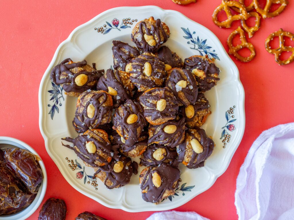 Finished Chocolate Peanut Butter Pretzel Bites topped with flakey salt and additional peanuts, ready to be enjoyed as a delicious snack.