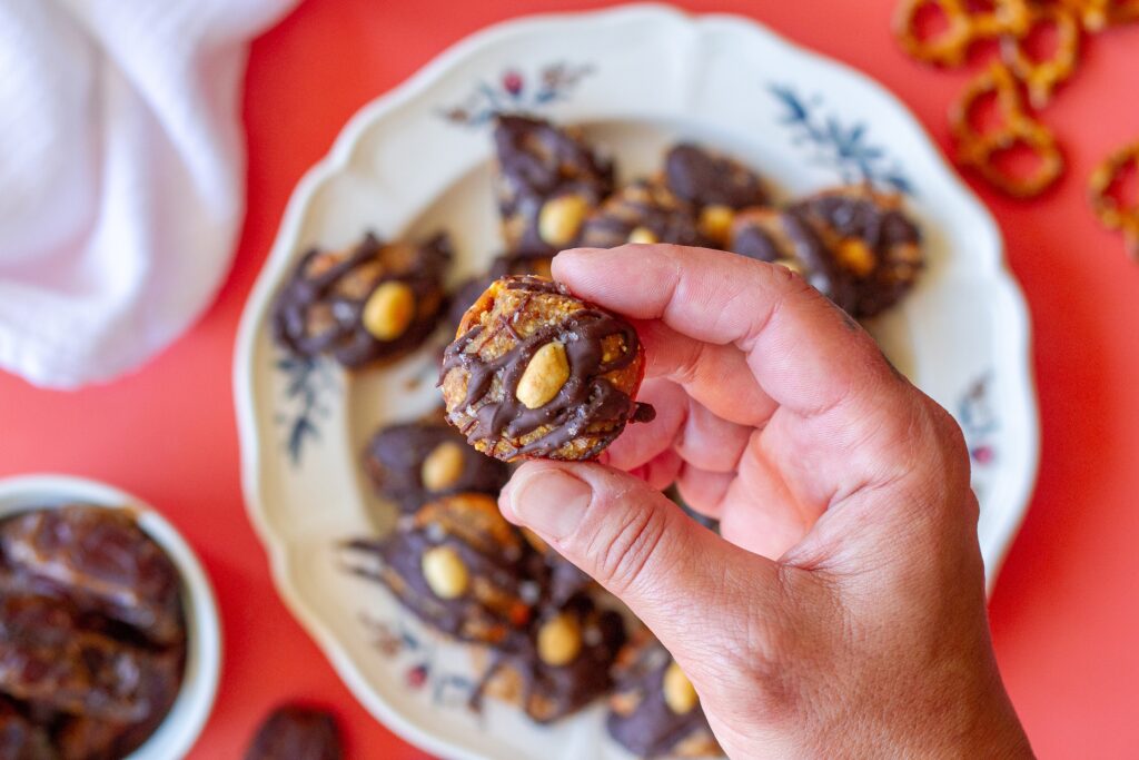 Finished Chocolate Peanut Butter Pretzel Bites topped with flakey salt and additional peanuts, ready to be enjoyed as a delicious snack.