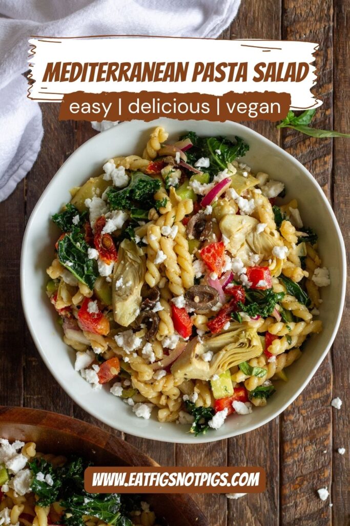 Finished Vegan Mediterranean Pasta Salad garnished with vegan feta crumbles and fresh basil leaves.