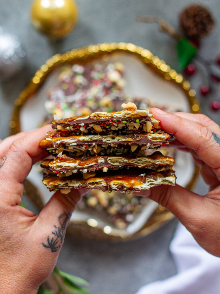 A close-up view of Christmas Cracker Toffee highlighting the crunchy layers and chocolate topping.