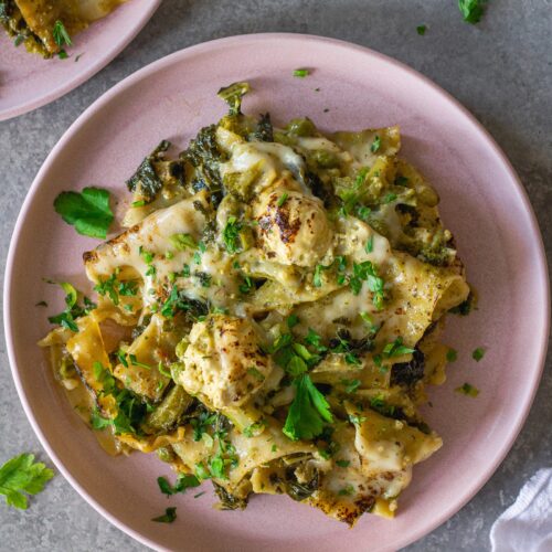 Finished lasagna topped with melty mozzarella, dollops of tofu ricotta, and fresh parsley