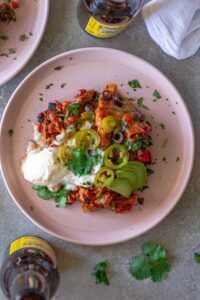 Overhead shot of the finished One Pan Chick’n Enchilada Skillet garnished with avocado, cilantro, and jalapeños