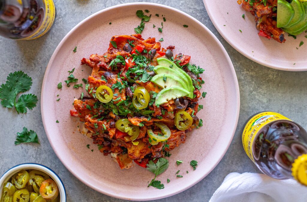 Overhead shot of the finished One Pan Chick’n Enchilada Skillet garnished with avocado, cilantro, and jalapeños