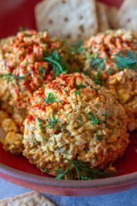 Bowl of Southern‑style vegan ‘chicken’ salad with golden baked tofu, diced tofu, celery, and herbs, topped with smoked paprika.