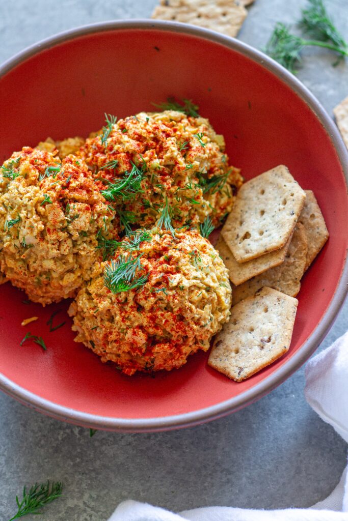 Bowl of Southern‑style vegan ‘chicken’ salad with golden baked tofu, diced tofu, celery, and herbs, topped with smoked paprika.