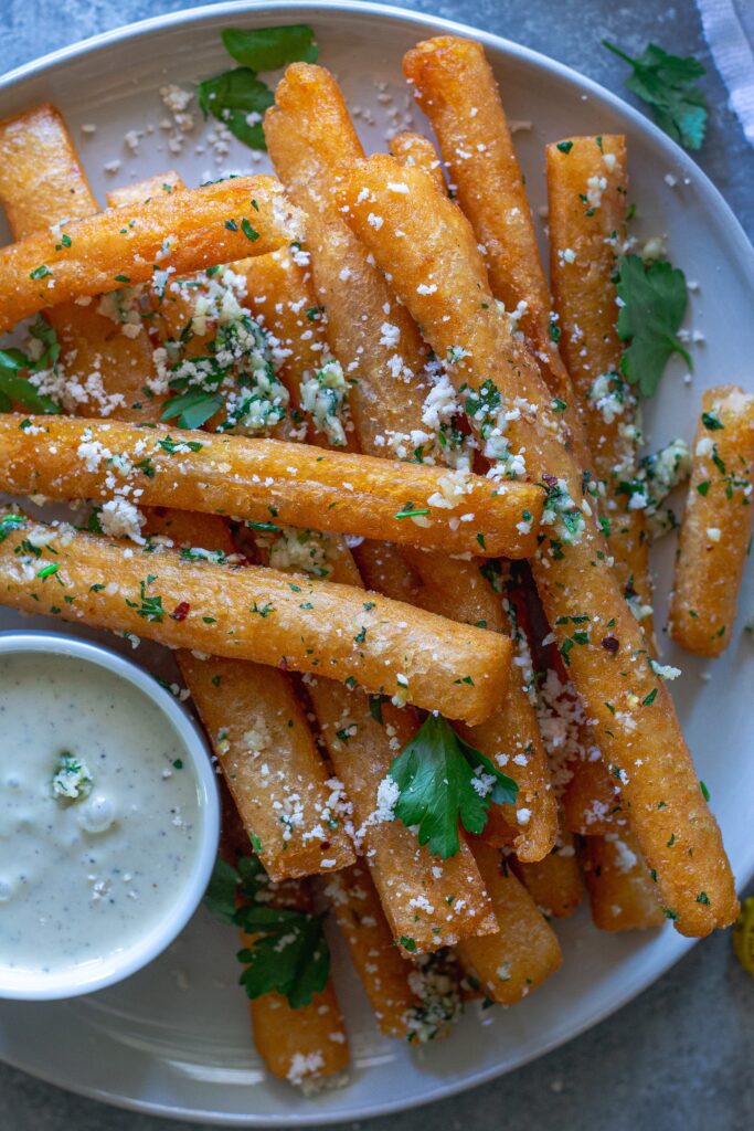 Golden‑brown Japanese‑style long fries tossed in garlic‑parmesan butter, sprinkled with fresh parsley and a side of garlic aioli.