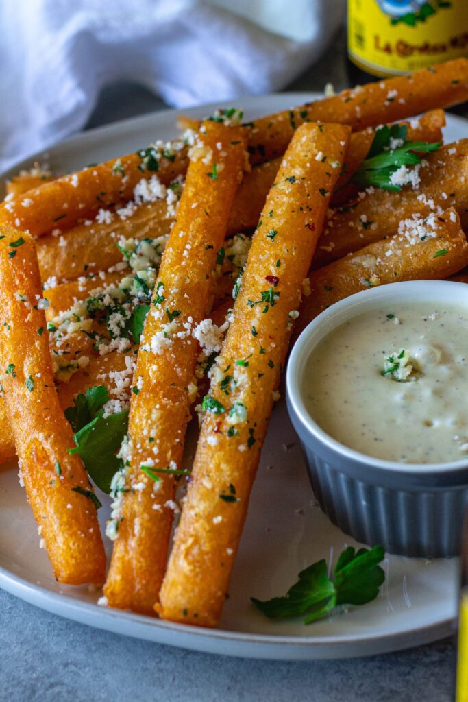 Golden‑brown Japanese‑style long fries tossed in garlic‑parmesan butter, sprinkled with fresh parsley and a side of garlic aioli.