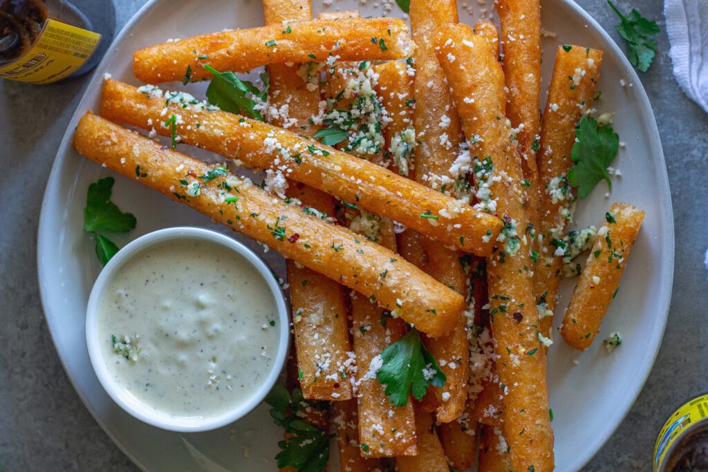 Golden‑brown Japanese‑style long fries tossed in garlic‑parmesan butter, sprinkled with fresh parsley and a side of garlic aioli.
