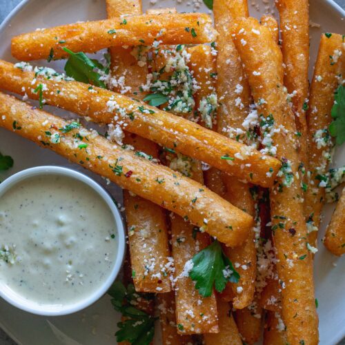 Golden‑brown Japanese‑style long fries tossed in garlic‑parmesan butter, sprinkled with fresh parsley and a side of garlic aioli.
