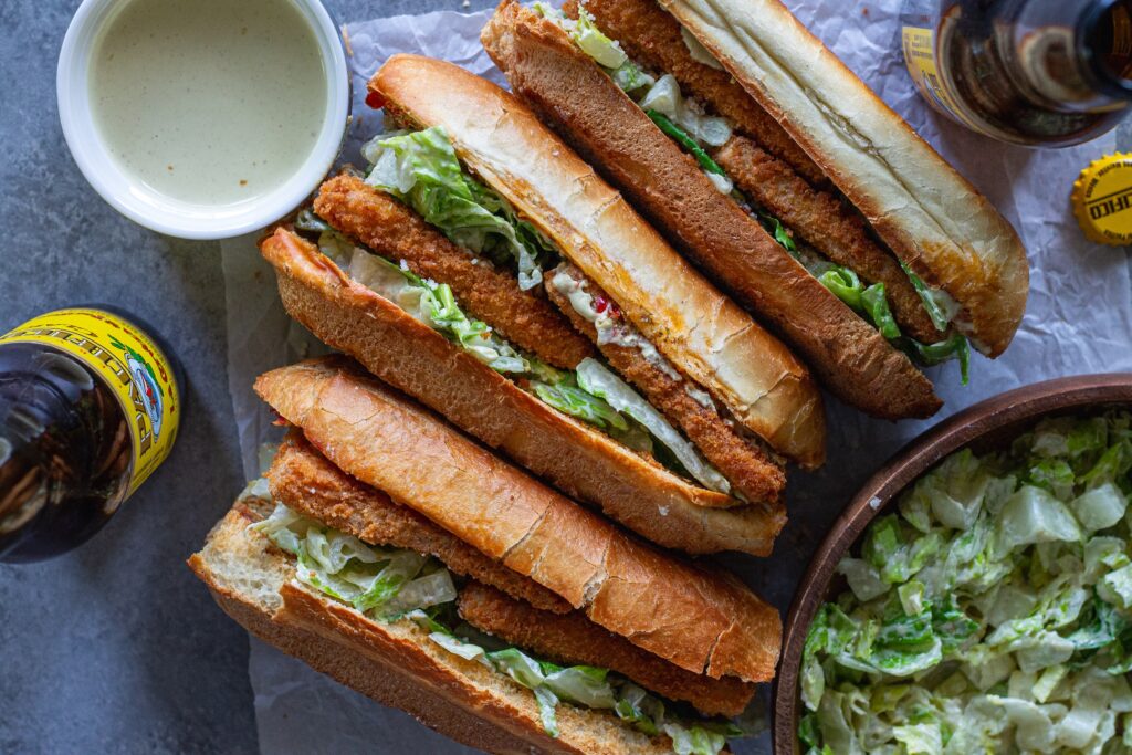 Golden brown crispy tofu Caesar sandwich on a toasted sub roll with roasted garlic Calabrian butter, topped with fresh romaine and vegan parmesan.