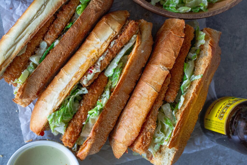 Golden brown crispy tofu Caesar sandwich on a toasted sub roll with roasted garlic Calabrian butter, topped with fresh romaine and vegan parmesan.