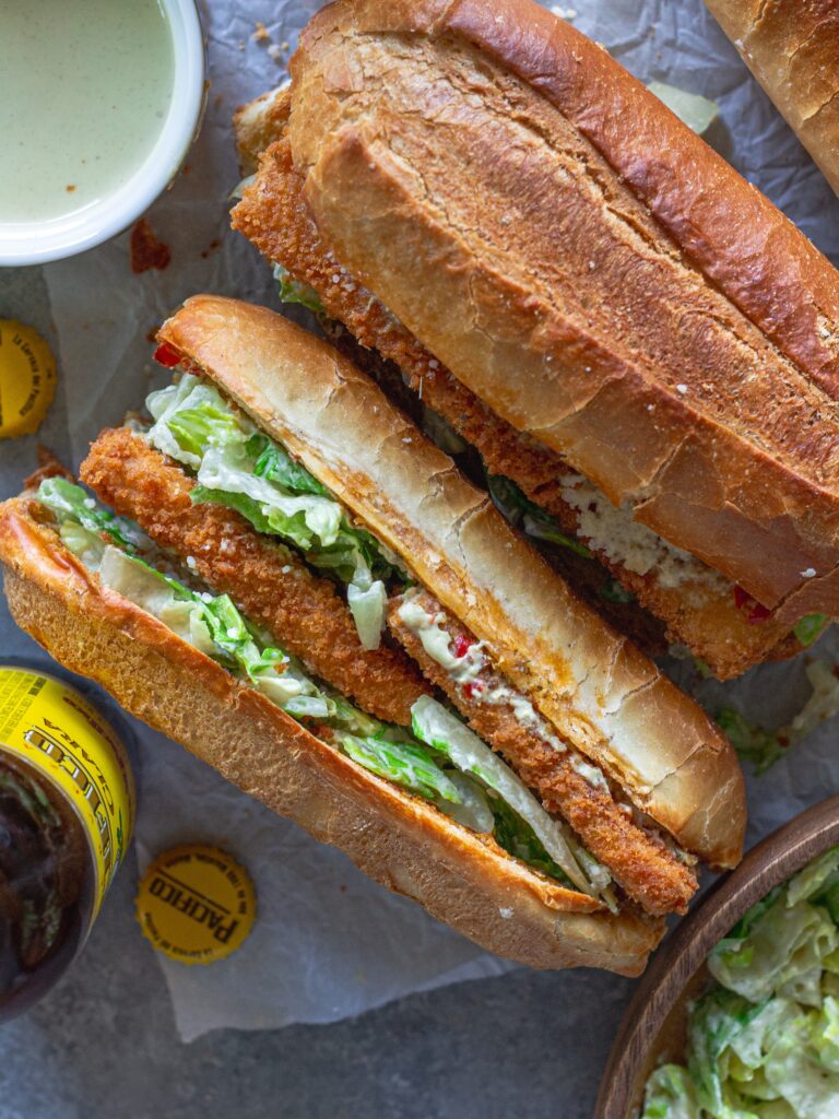 Golden brown crispy tofu Caesar sandwich on a toasted sub roll with roasted garlic Calabrian butter, topped with fresh romaine and vegan parmesan.