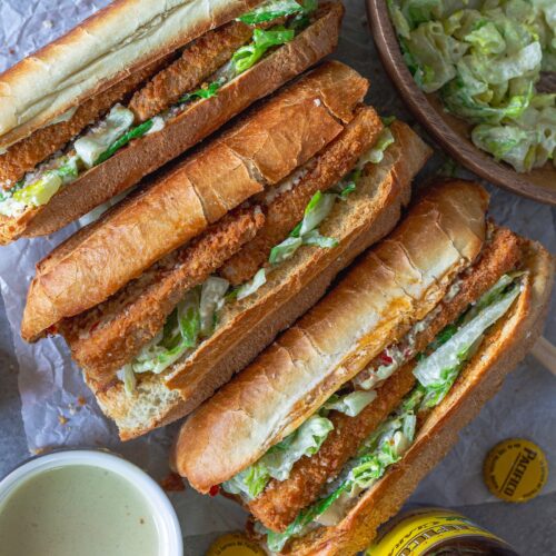 Golden brown crispy tofu Caesar sandwich on a toasted sub roll with roasted garlic Calabrian butter, topped with fresh romaine and vegan parmesan.