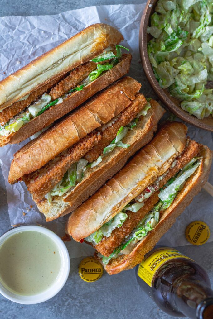 Golden brown crispy tofu Caesar sandwich on a toasted sub roll with roasted garlic Calabrian butter, topped with fresh romaine and vegan parmesan.