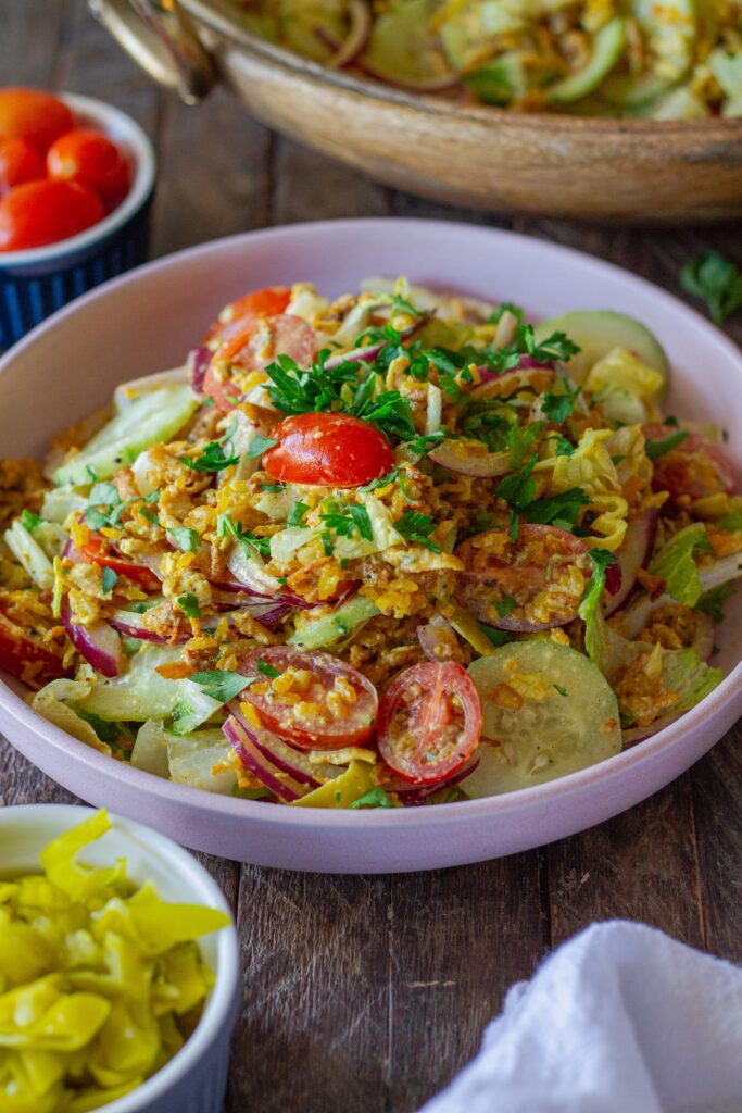 Tofu Shawarma-Inspired Crispy Rice Salad in a large bowl with fresh vegetables and garlicky dressing