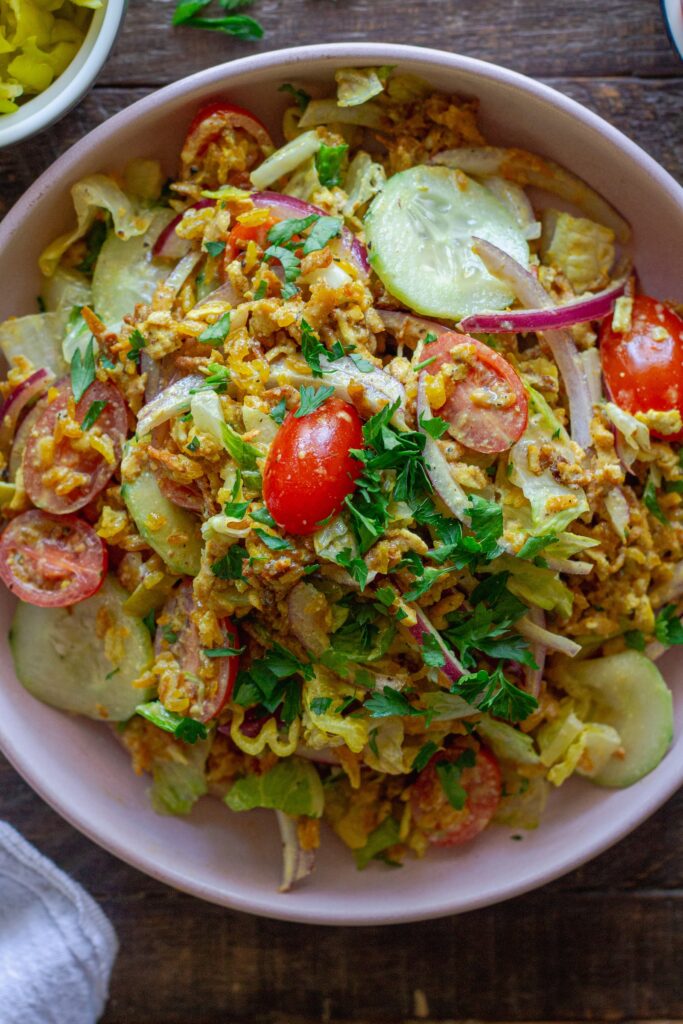 Tofu Shawarma-Inspired Crispy Rice Salad in a large bowl with fresh vegetables and garlicky dressing