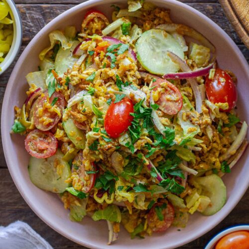 Tofu Shawarma-Inspired Crispy Rice Salad in a large bowl with fresh vegetables and garlicky dressing