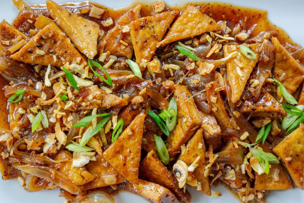 Close-up of crispy tofu adobo showing sauce coating texture