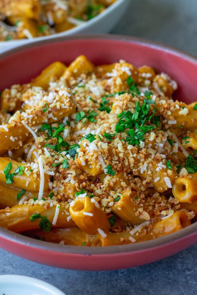 Bowl of creamy hidden veggie pasta topped with golden garlicky breadcrumbs and fresh parsley.