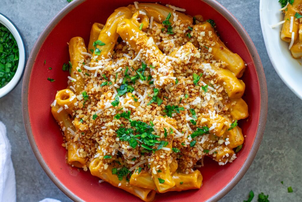 Bowl of creamy hidden veggie pasta topped with golden garlicky breadcrumbs and fresh parsley.