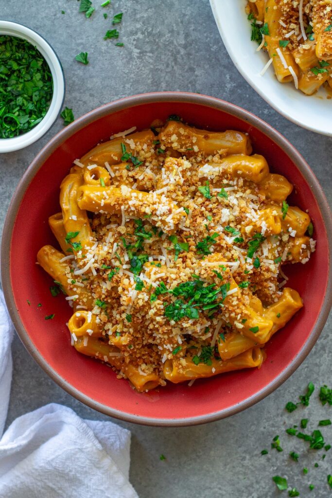 Bowl of creamy hidden veggie pasta topped with golden garlicky breadcrumbs and fresh parsley.