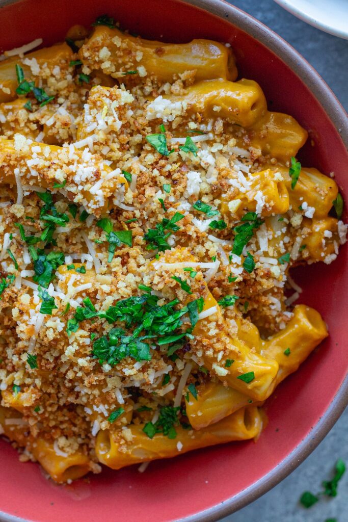 Bowl of creamy hidden veggie pasta topped with golden garlicky breadcrumbs and fresh parsley.