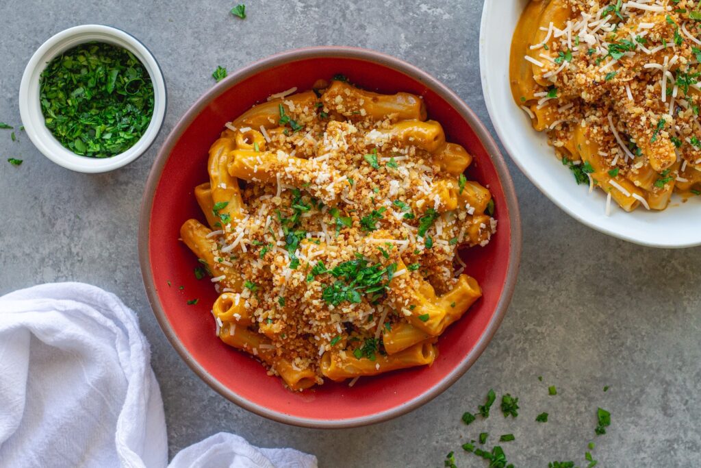 Bowl of creamy hidden veggie pasta topped with golden garlicky breadcrumbs and fresh parsley.