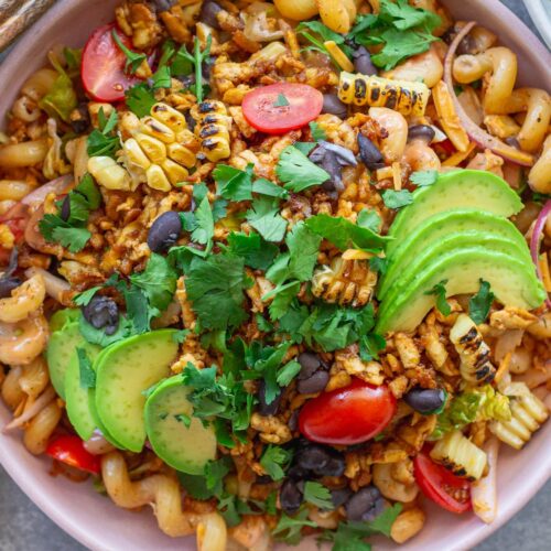 Vegan BBQ chicken pasta salad in a large bowl with crispy tofu, colorful vegetables, and creamy BBQ ranch dressing