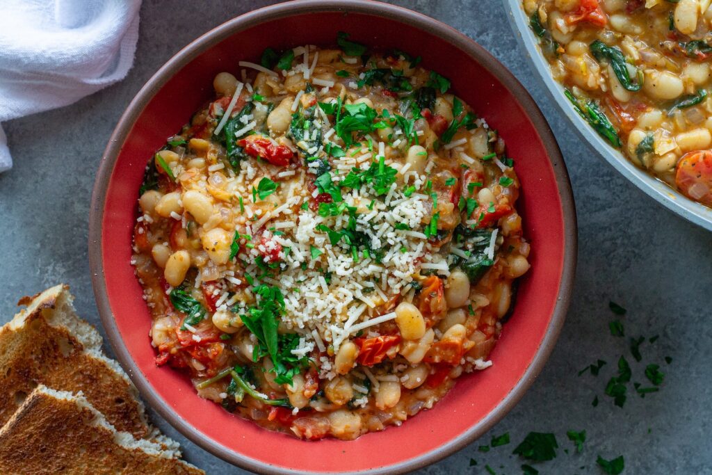 Finished creamy tuscan white bean skillet topped with parmesan and parsley
