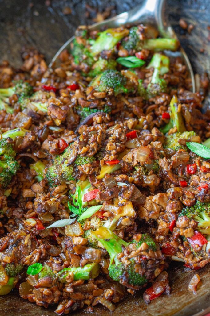 Broccoli tofu stir-fry with sesame seeds and green onion garnish