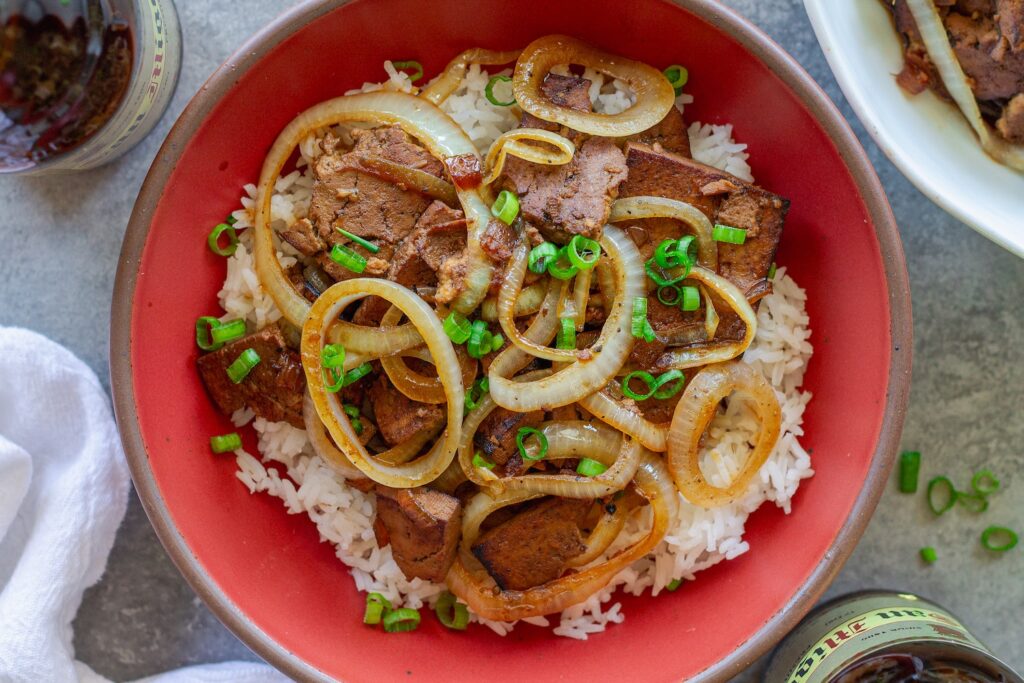 Vegan bistek tagalog with braised tofu and caramelized onion rings served over steamed rice.