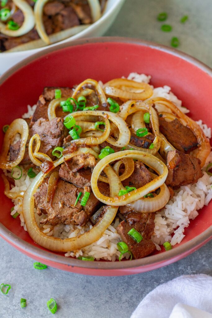 Vegan bistek tagalog with braised tofu and caramelized onion rings served over steamed rice.