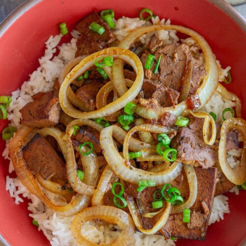 Vegan bistek tagalog with braised tofu and caramelized onion rings served over steamed rice.